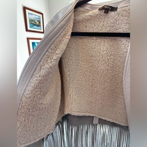 Sky white leather jacket with fringe.